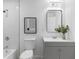Modern bathroom with gray vanity, marble tile, and updated fixtures at 1921 Westwood Sw Ave, Atlanta, GA 30310