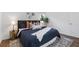 King-size bed, stylish decor, and hardwood floors at 1921 Westwood Sw Ave, Atlanta, GA 30310