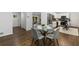 Open concept dining area with hardwood floors, a glass-top table, and views into the kitchen at 1921 Westwood Sw Ave, Atlanta, GA 30310