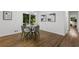 Modern dining room with hardwood floors, a glass-top table, and access to the backyard at 1921 Westwood Sw Ave, Atlanta, GA 30310