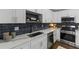 Modern kitchen with white cabinets, stainless steel appliances, and quartz countertops at 1921 Westwood Sw Ave, Atlanta, GA 30310