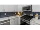 Stainless steel appliances and white shaker cabinets in this modern kitchen at 1921 Westwood Sw Ave, Atlanta, GA 30310