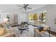 Living room with hardwood floors, large windows, comfortable seating, and a ceiling fan at 1921 Westwood Sw Ave, Atlanta, GA 30310