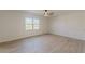Spacious bedroom with ceiling fan and wood-look floors at 1990 Old Concord Se Dr, Covington, GA 30016