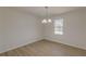 Simple dining room with light flooring and a chandelier at 1990 Old Concord Se Dr, Covington, GA 30016