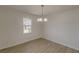Simple dining room with light flooring and a chandelier at 1990 Old Concord Se Dr, Covington, GA 30016