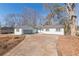 Newly renovated single-story home with a large driveway and mature trees at 1990 Old Concord Se Dr, Covington, GA 30016