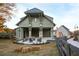 Beautifully designed exterior of a barn-style home with a covered patio, seating area, and manicured landscaping at 84 Black Gum Ln # 44, Auburn, GA 30011