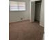 A simple bedroom featuring carpet flooring, neutral walls, and a closet at 1473 Brownleaf Dr, Jonesboro, GA 30236