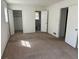 Bedroom with doorways to the ensuite bathroom and closet ready for renovation and customization with carpet flooring at 1473 Brownleaf Dr, Jonesboro, GA 30236