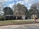 Charming single-story home featuring a well-maintained lawn and a beautiful flowering tree at 1473 Brownleaf Dr, Jonesboro, GA 30236