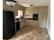 Functional kitchen with neutral cabinets, a black refrigerator, and linoleum flooring at 1473 Brownleaf Dr, Jonesboro, GA 30236