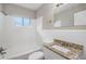 Clean bathroom, granite countertop, and white tile at 2077 Rosewood Rd, Decatur, GA 30032