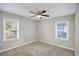 Well-lit bedroom with ceiling fan and two windows at 2077 Rosewood Rd, Decatur, GA 30032