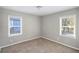 Spacious bedroom featuring neutral walls and two large windows at 2077 Rosewood Rd, Decatur, GA 30032