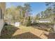 Spacious backyard with mature trees and lawn, enclosed by a chain link fence at 2649 Santa Barbara Nw Dr, Atlanta, GA 30318