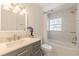 Bright bathroom featuring a vanity with a large mirror and a shower tub combo at 2649 Santa Barbara Nw Dr, Atlanta, GA 30318