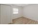 Well-lit bedroom featuring wood-look floors and closet at 2649 Santa Barbara Nw Dr, Atlanta, GA 30318