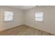 This bright bedroom features two windows, natural light and light-colored, wood-look flooring at 2649 Santa Barbara Nw Dr, Atlanta, GA 30318