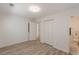 Well-lit bedroom featuring wood-look floors and closet at 2649 Santa Barbara Nw Dr, Atlanta, GA 30318
