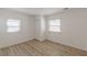 This bedroom features wood-look floors, two windows letting in natural light, and closet for storage at 2649 Santa Barbara Nw Dr, Atlanta, GA 30318