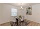 Cozy dining room featuring a dark wood table with seating for four and a bright window at 2649 Santa Barbara Nw Dr, Atlanta, GA 30318