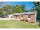 Brick ranch home with a well-maintained lawn and landscaping at 2649 Santa Barbara Nw Dr, Atlanta, GA 30318