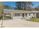 Quaint home featuring painted gray brick, a covered carport, and a tidy yard at 2649 Santa Barbara Nw Dr, Atlanta, GA 30318