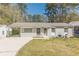 Charming single-story home with a freshly painted gray brick exterior, carport, and well-manicured front yard at 2649 Santa Barbara Nw Dr, Atlanta, GA 30318