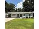 Charming home with a well-maintained front lawn and grey painted brick exterior and a carport at 2649 Santa Barbara Nw Dr, Atlanta, GA 30318