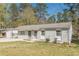 Charming single-story home with a long drive way and carport and a grey painted brick exterior at 2649 Santa Barbara Nw Dr, Atlanta, GA 30318