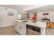 Bright kitchen featuring a central island with white cabinets and stainless steel appliances at 2649 Santa Barbara Nw Dr, Atlanta, GA 30318
