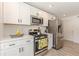 Modern kitchen boasting stainless steel appliances, bright white cabinets, and sleek countertops at 2649 Santa Barbara Nw Dr, Atlanta, GA 30318