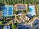 An overhead view of community amenities including tennis courts, playground, pool and parking at 535 Cape Ivey Dr, Dacula, GA 30019