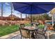 Outdoor patio with seating and a grill is great for entertainment, underneath the shade of a large umbrella at 535 Cape Ivey Dr, Dacula, GA 30019
