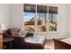 Comfortable bedroom seating area with large window letting in lots of natural light and views of the landscaped backyard at 535 Cape Ivey Dr, Dacula, GA 30019