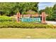 A wooden sign with the community name 'Ivey Chase' adding charm and character to the neighborhood entrance at 535 Cape Ivey Dr, Dacula, GA 30019