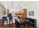 A spacious dining area with hardwood floors and modern lighting connects seamlessly to the kitchen at 535 Cape Ivey Dr, Dacula, GA 30019