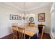 Charming dining room with hardwood floors, stylish wainscoting, and elegant lighting, creating a refined ambiance at 535 Cape Ivey Dr, Dacula, GA 30019