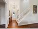 Grand foyer with a staircase, hardwood floors, and decorative chandelier, adding a touch of elegance at 535 Cape Ivey Dr, Dacula, GA 30019