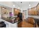 Modern kitchen features granite countertops, stainless steel appliances, and a breakfast bar with pendant lighting at 535 Cape Ivey Dr, Dacula, GA 30019