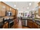 Open-concept kitchen with stainless appliances, granite counters, and views into the dining and living areas at 535 Cape Ivey Dr, Dacula, GA 30019