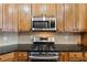 This kitchen includes stainless steel appliances and beautiful wood cabinets, complete with a modern microwave at 535 Cape Ivey Dr, Dacula, GA 30019