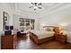 The main bedroom features a trey ceiling, hardwood floors, and large windows for natural light at 535 Cape Ivey Dr, Dacula, GA 30019