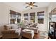 Cozy sun room with hardwood floors, comfortable furniture, lots of windows, and a ceiling fan at 535 Cape Ivey Dr, Dacula, GA 30019