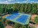 Overhead view of tennis courts surrounded by lush trees and greenery for outdoor recreation at 535 Cape Ivey Dr, Dacula, GA 30019