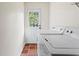 Bright laundry room with washer, dryer, and exterior access at 2070 Ridgedale Ne Rd, Atlanta, GA 30317