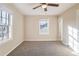 Bright bedroom featuring neutral walls, carpet, and two windows at 3336 Glenco Dr, Decatur, GA 30032