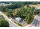 Expansive aerial view of the property, highlighting its generous lot size, surrounded by lush trees and convenient parking area at 4205 Jim Owens Nw Rd, Kennesaw, GA 30152