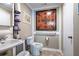 Clean bathroom with toilet, sink, and wall decor at 4205 Jim Owens Nw Rd, Kennesaw, GA 30152